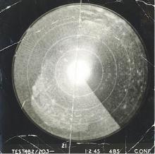 circular radar scope showing bright light in the middle which darkens behind the sweeping radius