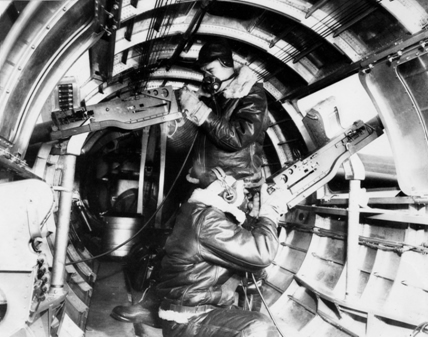 Waist gunners in position inside aircraft